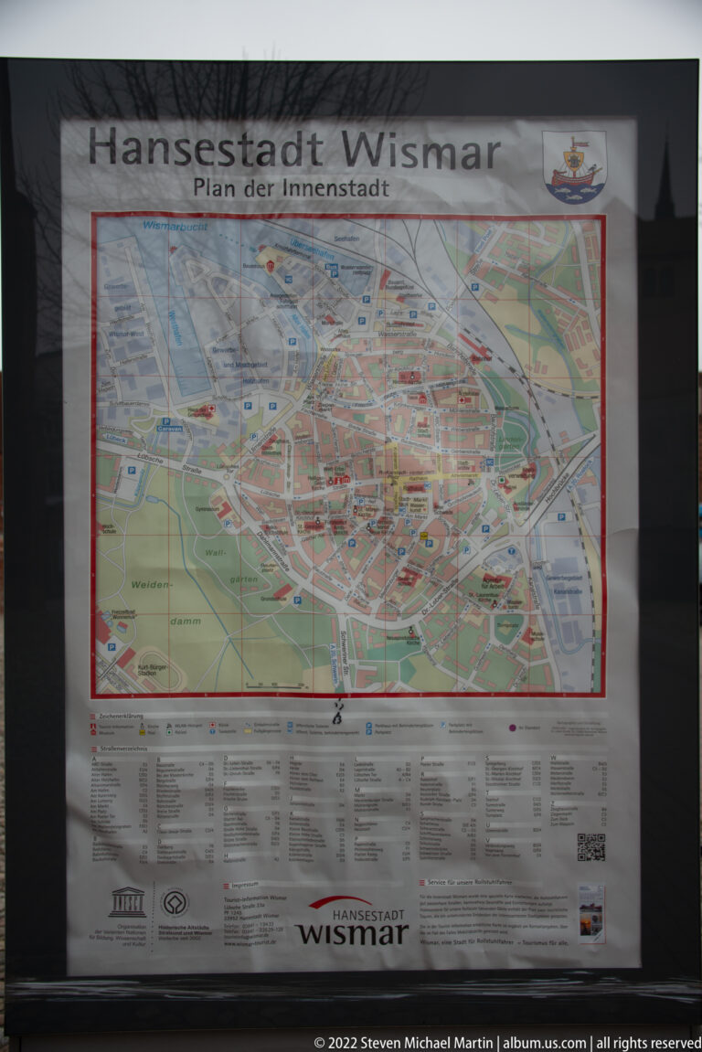 Public street map of Wismar’s inner city behind glass, showing the dense historic center and surrounding streets.