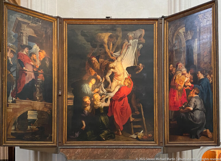 Open Baroque triptych with a crowded central scene around a pale draped body and separate narrative scenes on both wings.