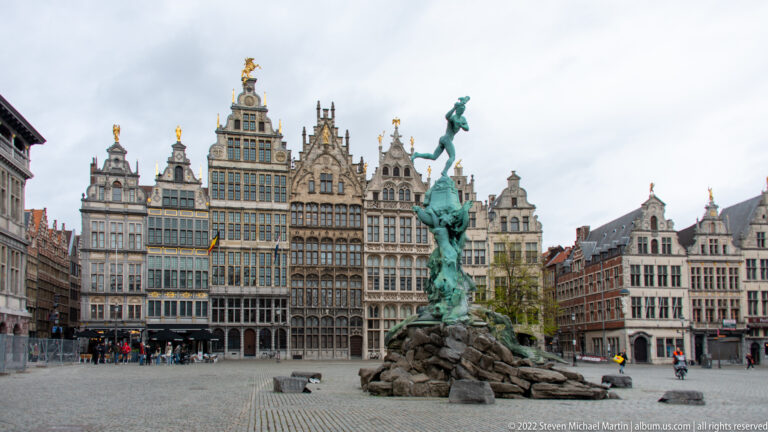 Brabo Fountain centered in Antwerp’s Grote Markt with ornate historic guild houses forming the backdrop.