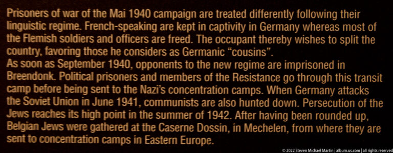 Close-up of English museum text discussing occupation, Breendonk, persecution, and deportations from Mechelen during the Second World War.