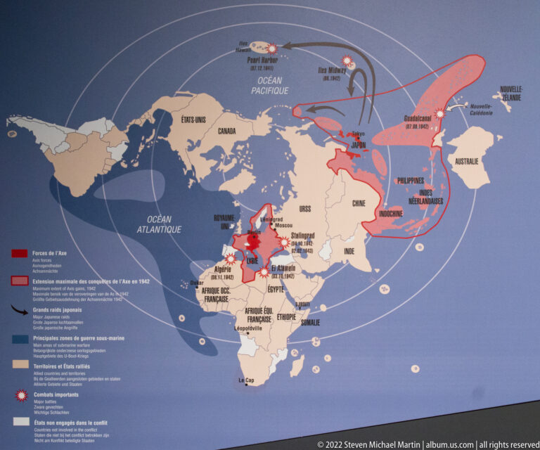 World map with red Axis-controlled areas, arrows, routes, and marked wartime theaters across Europe, Asia, Africa, and the Pacific.