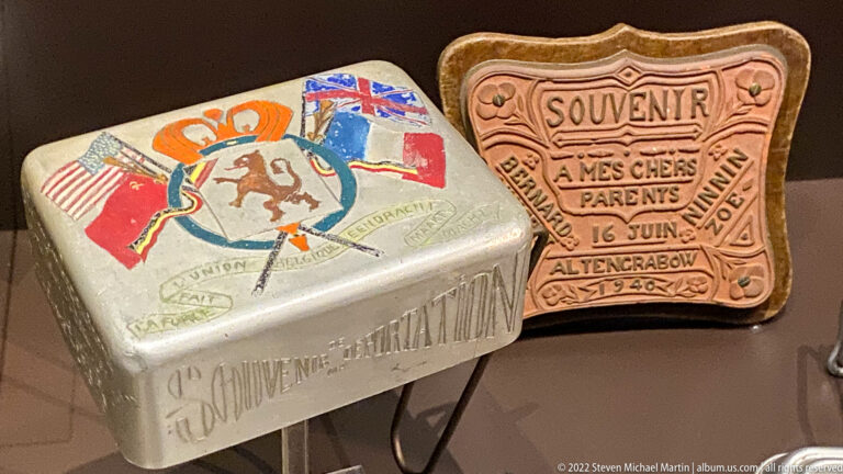 Two small decorated souvenir boxes, one with Allied flags and one dated 16 June 1945.