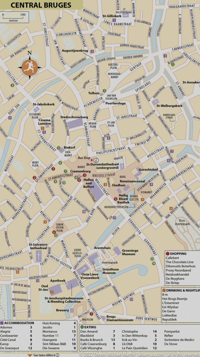 Printed map of central Bruges showing streets, canals, landmarks, visitor symbols, and a legend.