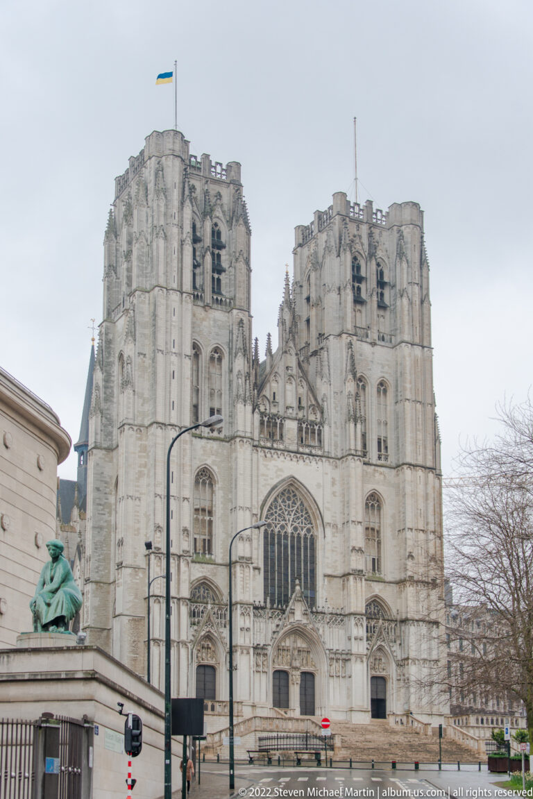 Wide view of the Cathedral of St. Michael and St. Gudula with twin towers, Gothic west façade, and street foreground.