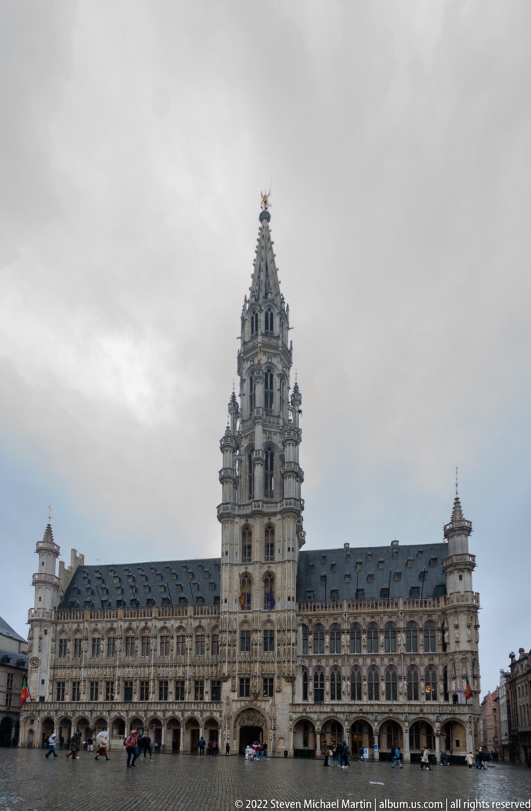 Wide frontal view of Brussels Town Hall on the Grand-Place, with its ornate Gothic façade, central tower, and cobbled square.