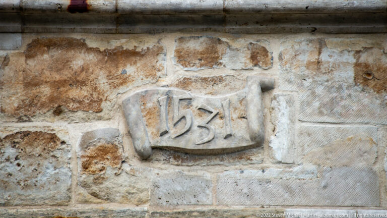 Small stone plaque carved with the date 1531 set into a weathered masonry wall.