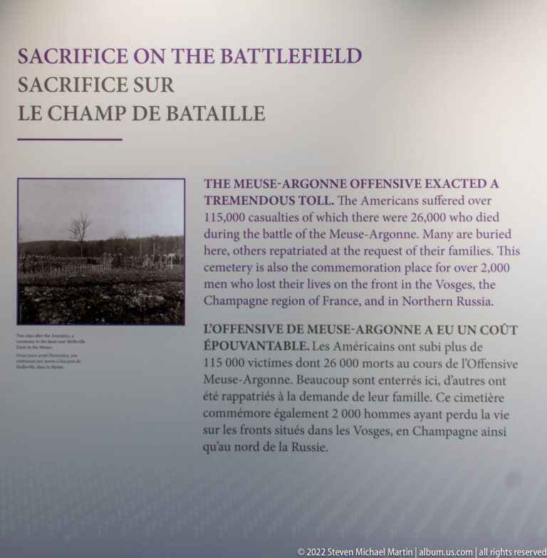 Interpretive panel with English and French text about the Meuse-Argonne battlefield and a historic landscape photograph.