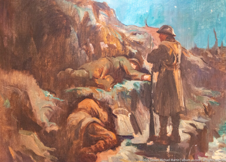 Painted soldiers tend wounded or fallen comrades among rough trenches and damaged battlefield ground.