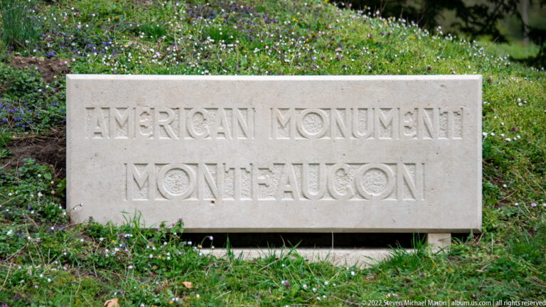Low stone marker in grass inscribed American Monument Montfaucon.