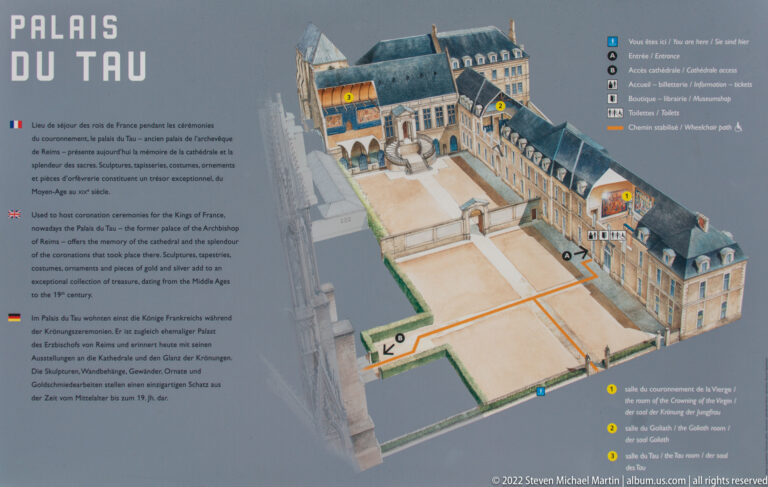 Interpretive panel with a bird’s-eye model of the Palais du Tau complex beside Reims Cathedral and a marked route.