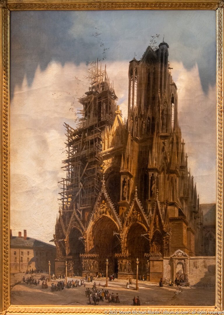 Historical view of Reims Cathedral with extensive timber scaffolding around the west towers and façade.