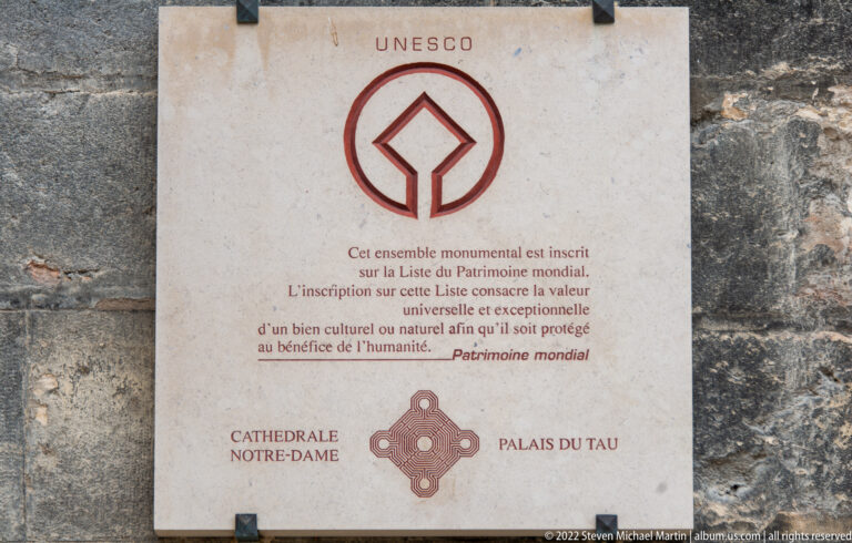 UNESCO World Heritage plaque naming Cathédrale Notre-Dame and Palais du Tau in Reims.