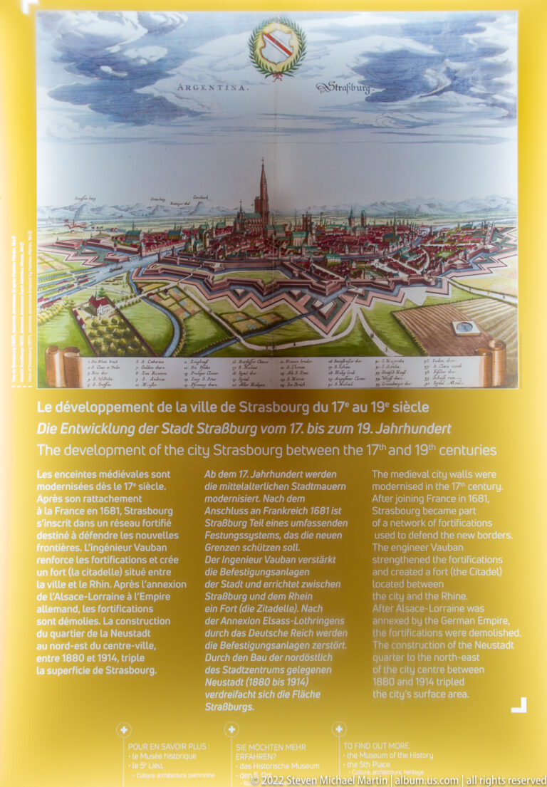 Trilingual museum panel about Strasbourg’s seventeenth- and eighteenth-century development beneath an illustrated fortified city plan.