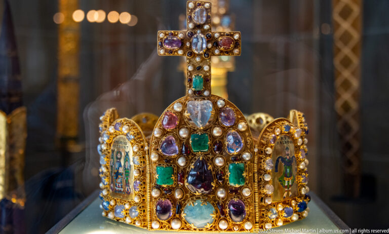 Jeweled gold crown with pearls, multicolored stones, enamel plaques, and a cross above the central arch.