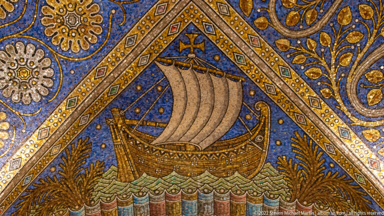 Single-masted sailing ship with pale sail and rigging crossing stylized waves in a blue mosaic panel.