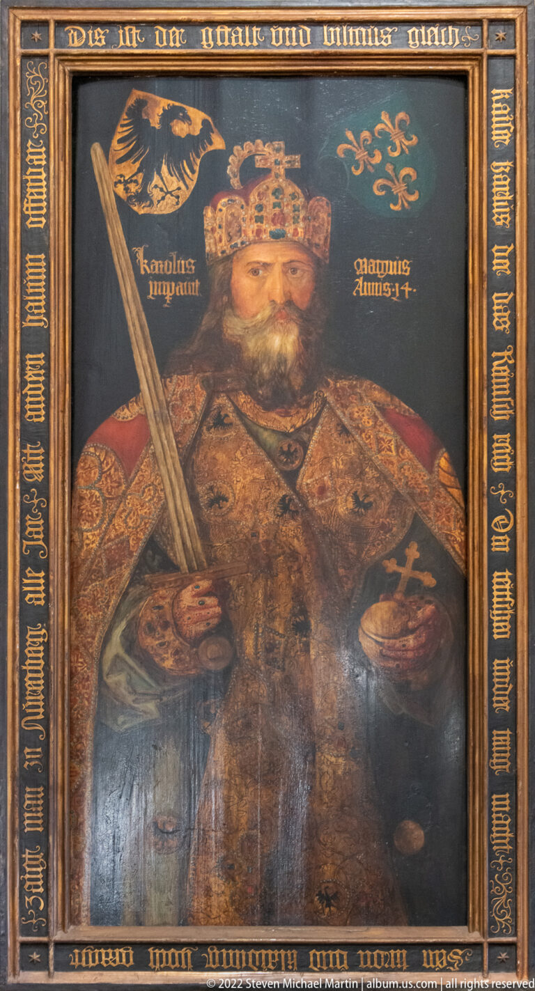 Painted portrait labeled Karolus Magnus, showing Charlemagne crowned and holding a sword and orb.