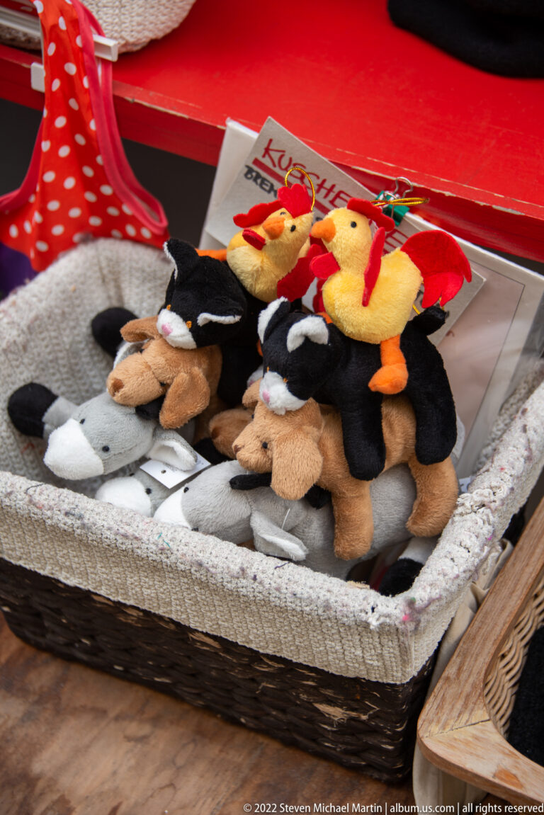 Basket of plush Bremen Town Musicians souvenirs featuring donkey, dog, cat, and rooster characters.