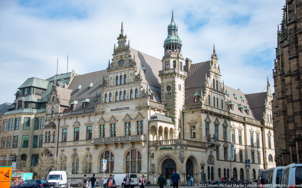 Elaborate Bremen Rathaus with steep roof, decorative gables, tower, and cathedral masonry at the right edge.