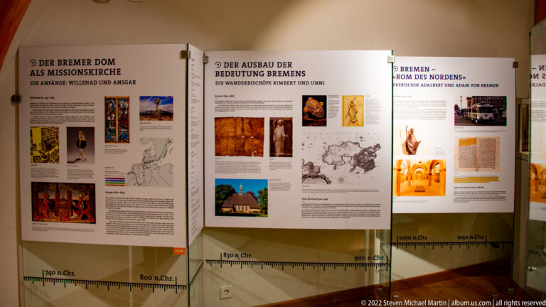 German-language museum panels about Bremen Cathedral’s missionary role and historical significance, with maps, images, and timeline.