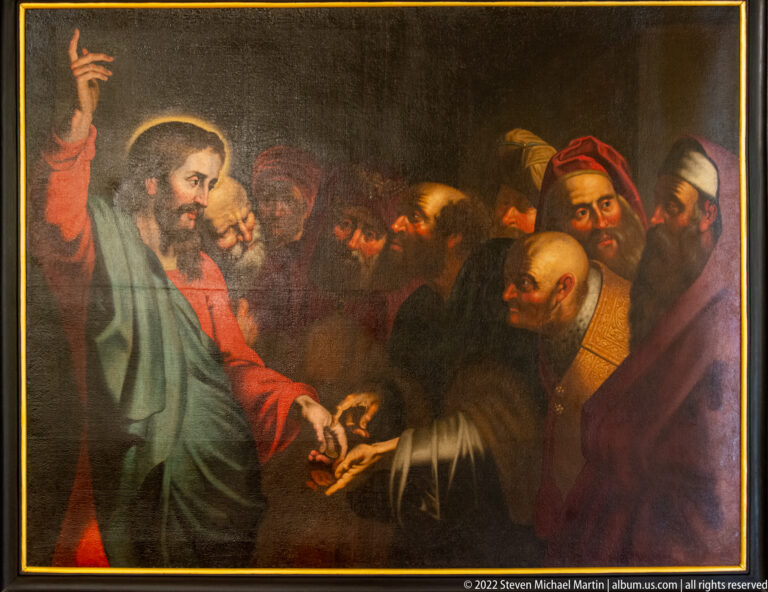 Religious painting of Christ gesturing toward a tightly grouped circle of men in an interior setting.
