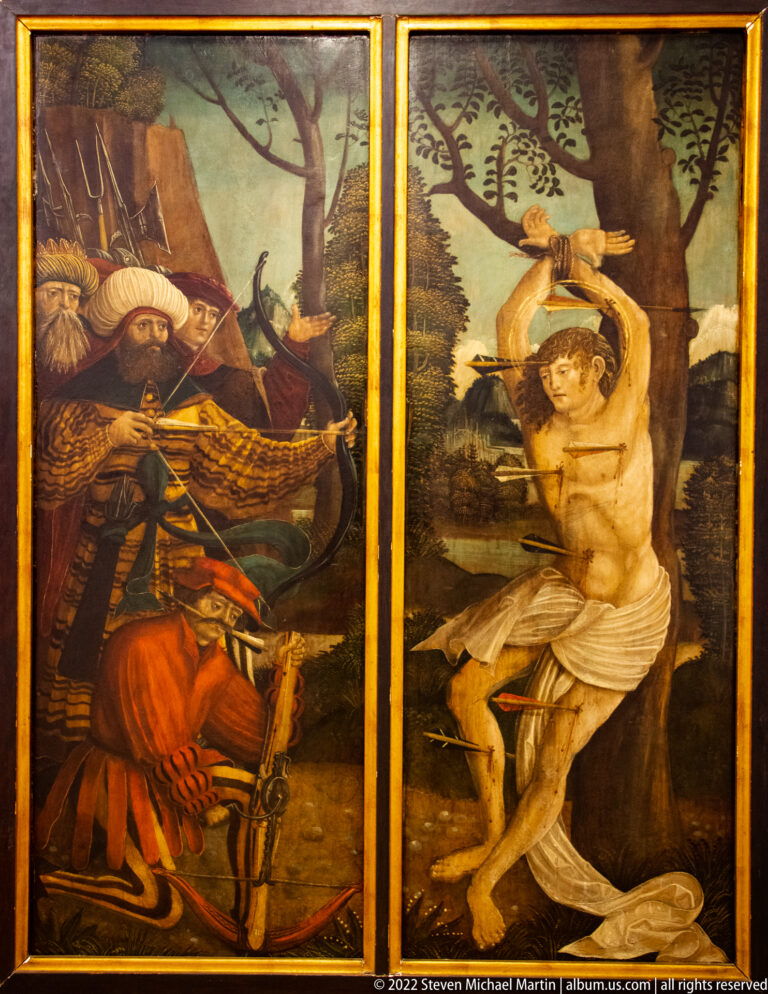 Two painted religious panels depicting separate martyrdom scenes in wooded landscapes.