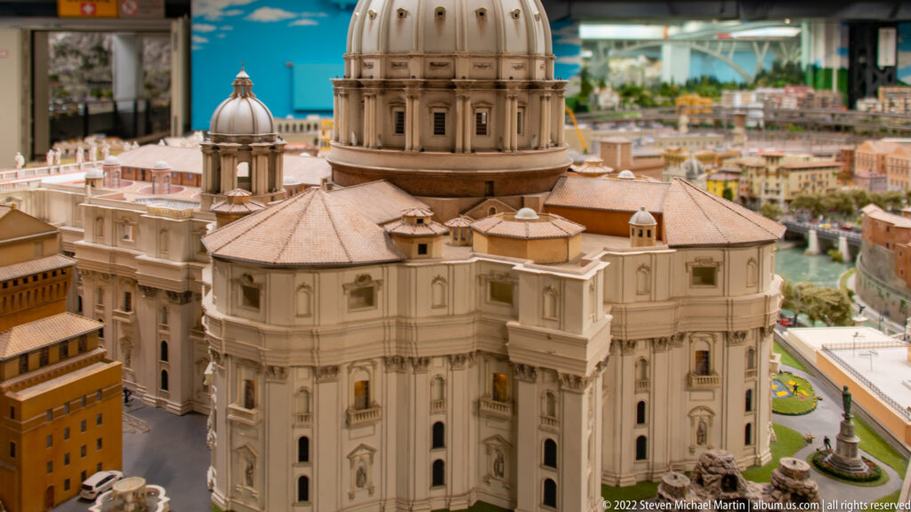 Miniature St. Peter’s Basilica seen from behind, with its great dome, smaller domes, and surrounding Vatican buildings.