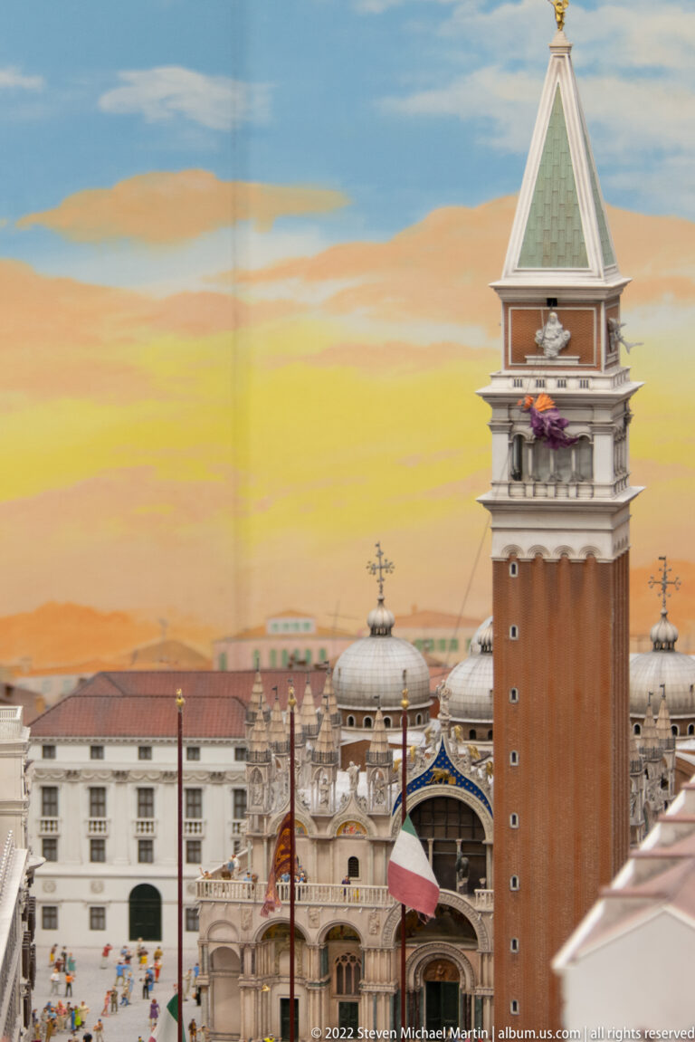 Miniature St. Mark’s Campanile rising beside the domes and roofline of St. Mark’s Basilica.