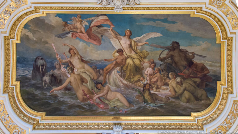 Large allegorical ceiling painting with classical figures, horses, water, and winged attendants in an ornate gilded frame.