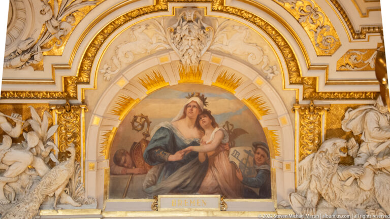 Painted female personification labeled “BREMEN” within ornate gilded stucco and flanking allegorical figures.