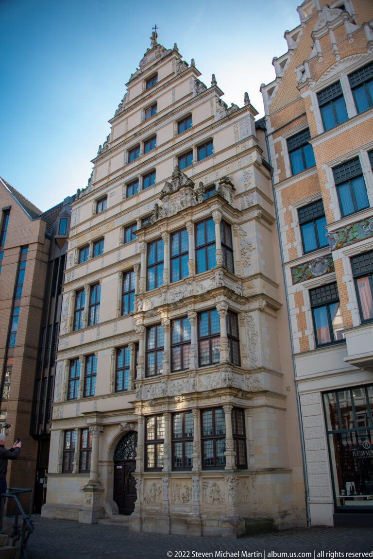 Leibnizhaus in Hannover with stepped gables, projecting windows, pale façade, and elaborate carved ornament.