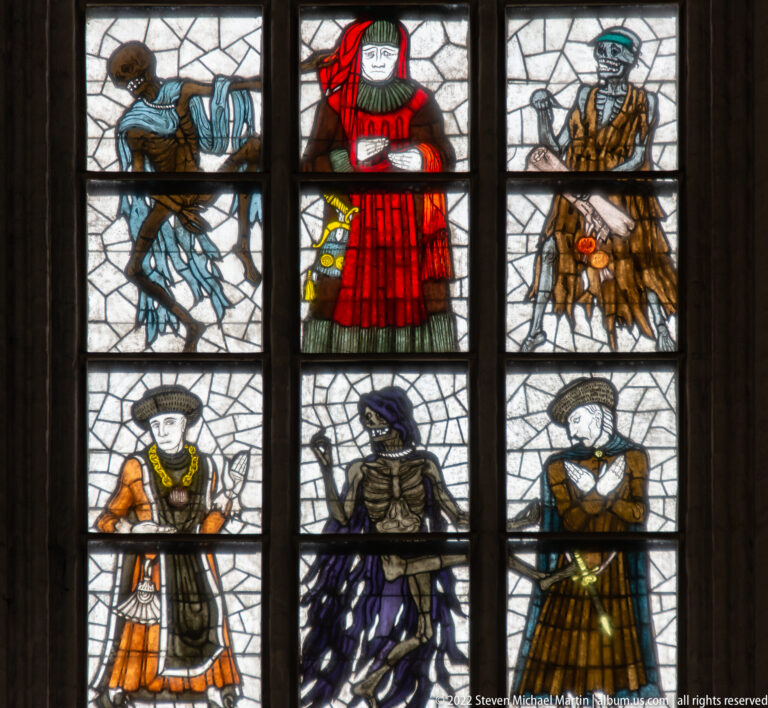 Six figures from Alfred Mahlau’s Dance of Death stained glass, including historical social types and skeletal figures outlined by dark leading.