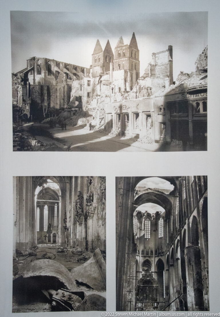 Display panel with black-and-white photographs of heavily damaged or roofless sections of St. Mary's Church.