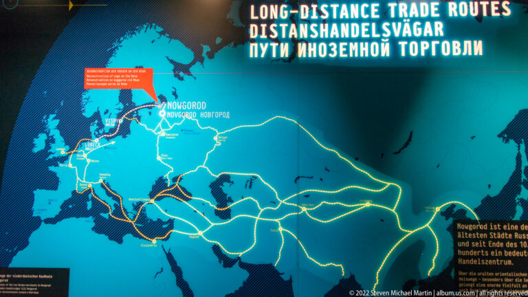 Illuminated museum map showing Hanseatic long-distance trade routes across Europe and toward Novgorod.