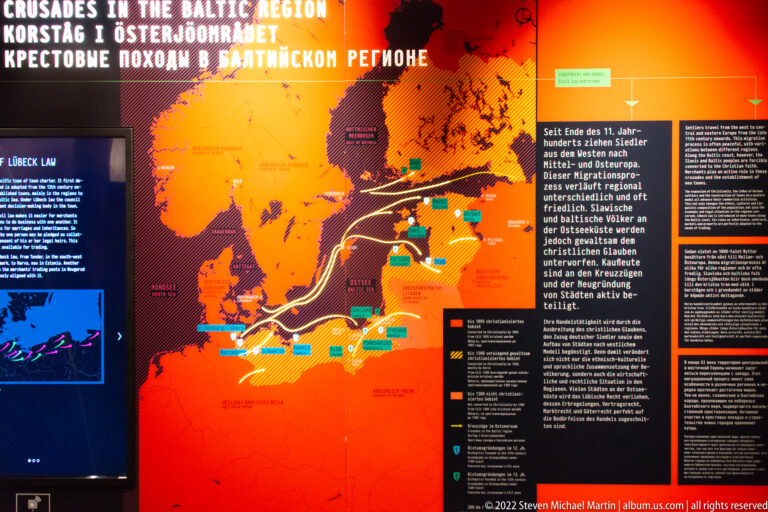 Large museum map about crusades and the Baltic region with route lines, dates, and explanatory text.