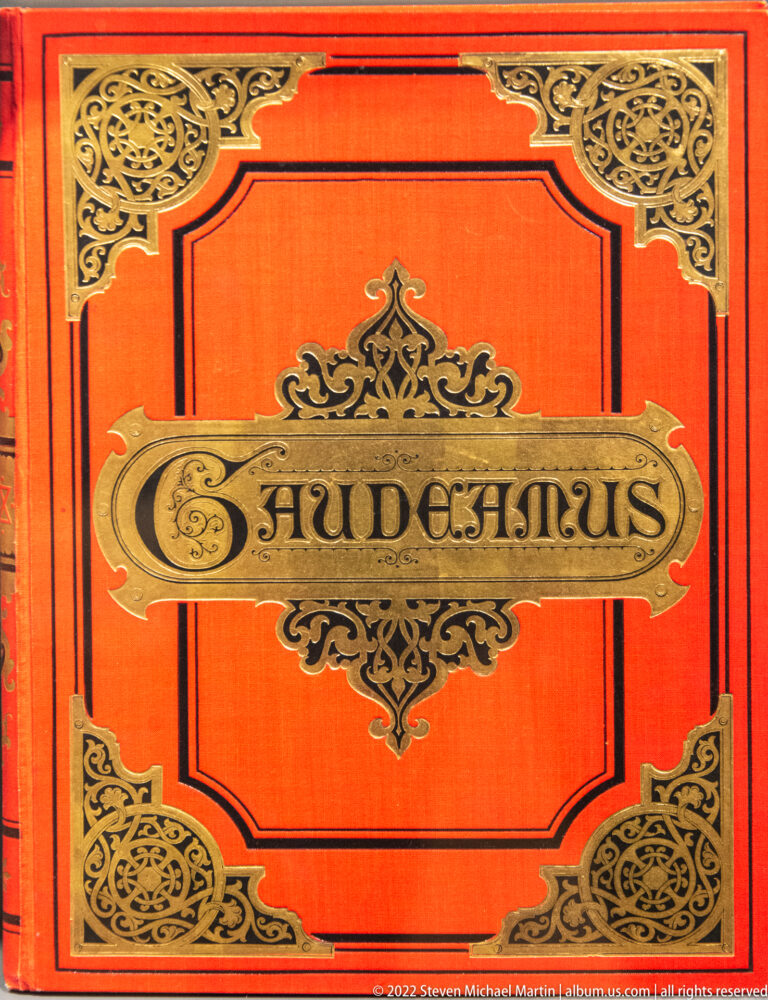 Ornate red book cover with black-and-gold decoration and the title “GAUDEAMUS” centered in a framed cartouche.