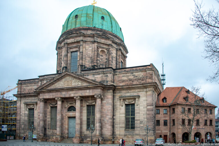 St. Elizabeth Church with classical columned façade, triangular pediment, and large green copper dome.