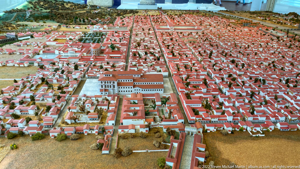 Scale model of Roman Trier with gridded streets, red-roofed buildings, large public complexes, and city walls.