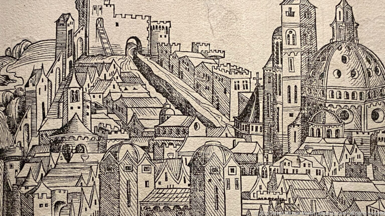 Black-and-white historic city view with dense rooftops, fortified walls, twin church towers, and a large domed church.