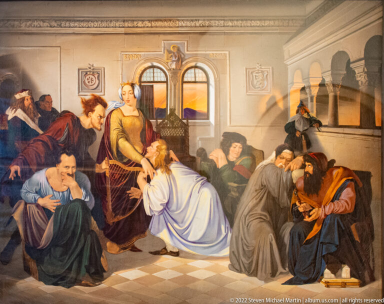 Historical painting of a crowded interior with kneeling, grieving, and consoling figures on a tiled floor.