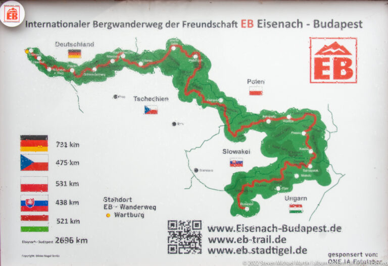 Map sign for the Eisenach–Budapest friendship hiking route, with country flags, distances, and a red route line.