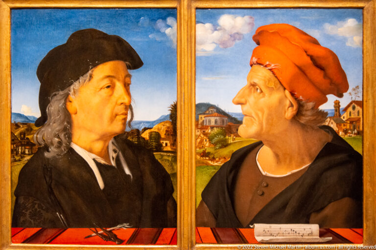Two paired male portraits in dark caps and clothing, each set before a distant landscape.