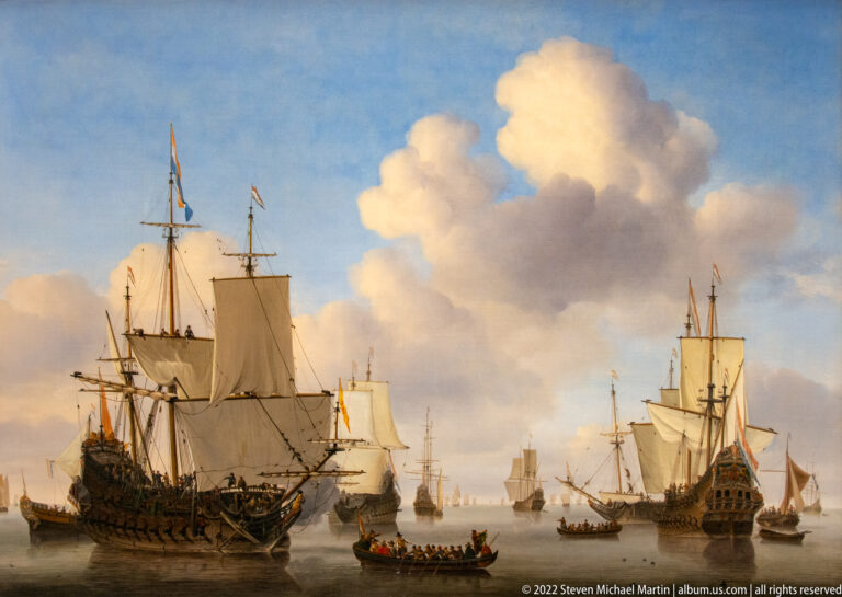 Large Dutch sailing ships and smaller boats gathered on calm water beneath towering clouds.