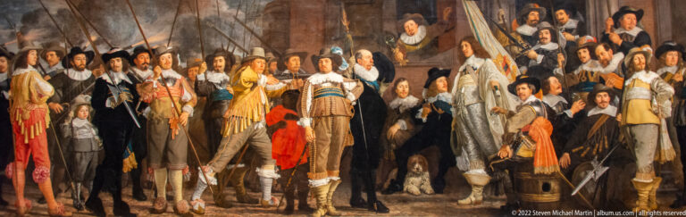 Large Dutch militia company posed with banner, officers, weapons, and elaborate seventeenth-century dress.