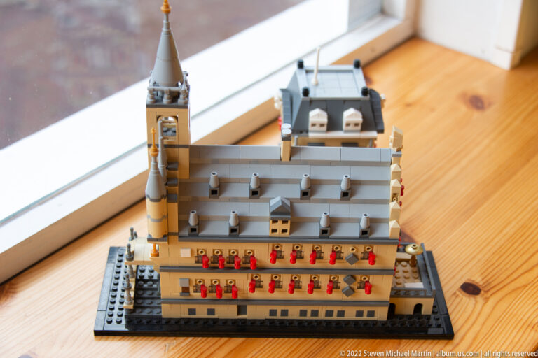 Close side view of a LEGO-style Dutch civic building model with stepped gable and tower.