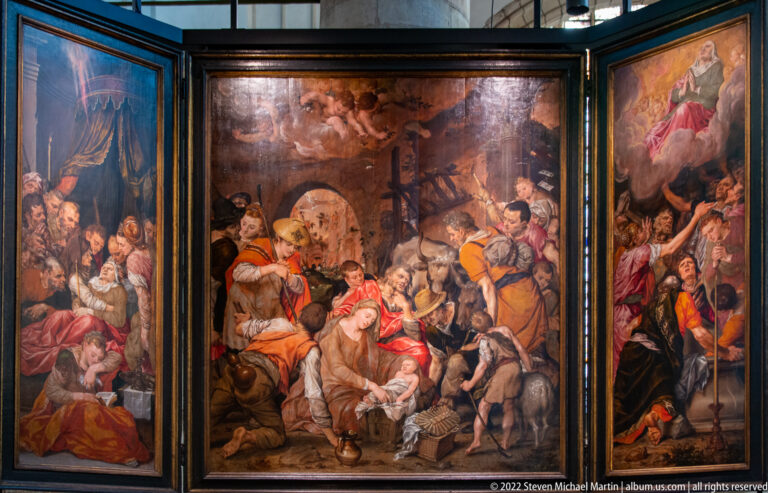 Three-panel religious painting with crowded biblical scenes and dramatic groups of figures.
