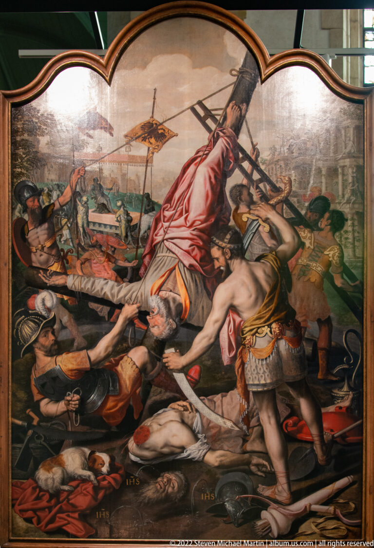 Large religious painting with armed figures, fallen bodies, spears, and a dramatic struggle in the foreground.