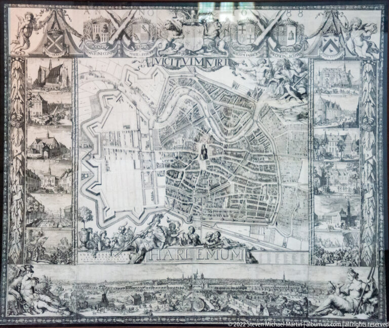 Historic engraved city plan of Haarlem showing fortifications, streets, surrounding vignettes, and the city name below.