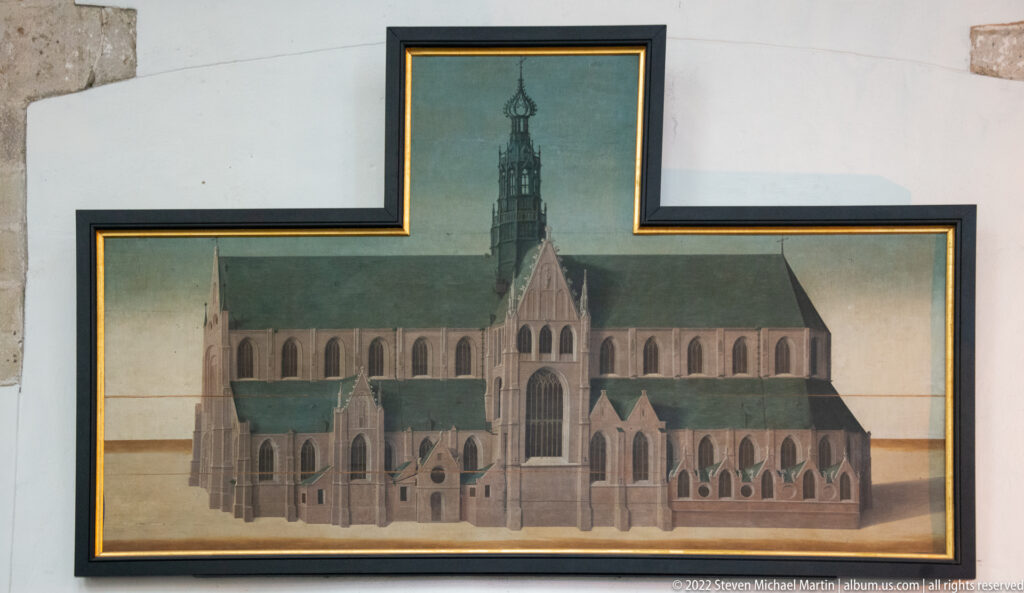 Framed side elevation drawing of a large Gothic church with crossing tower, buttresses, and pointed windows.