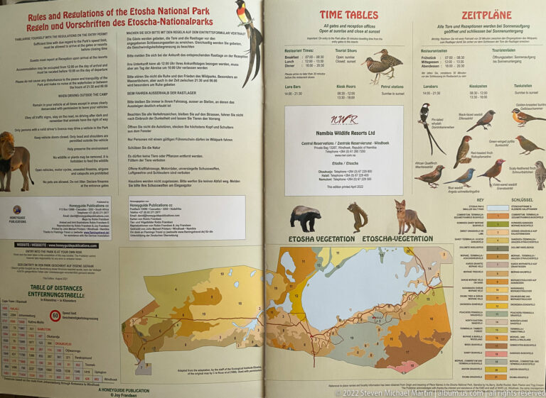 Open Etosha guide showing visitor information, timetables, animal illustrations, distance table, and a color-coded vegetation map.