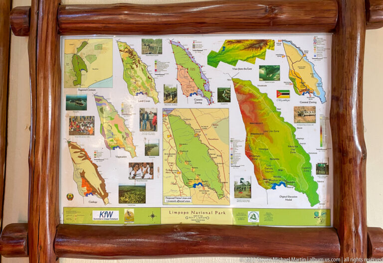 Framed interpretive display containing multiple color maps of Limpopo National Park and surrounding conservation areas.